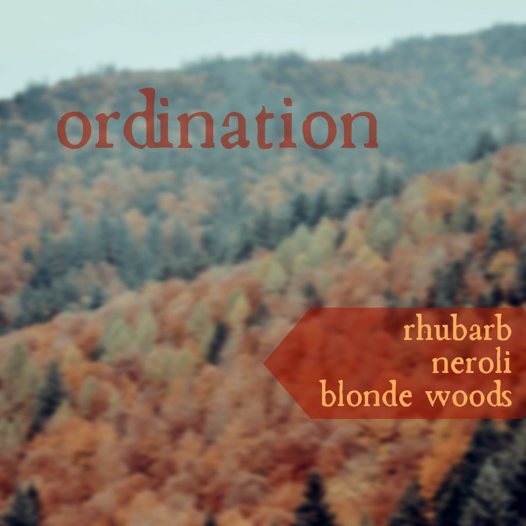 Ordination. Rhubarb, neroli, blonde woods. Image depicts forest covered hills with autum foliage. 